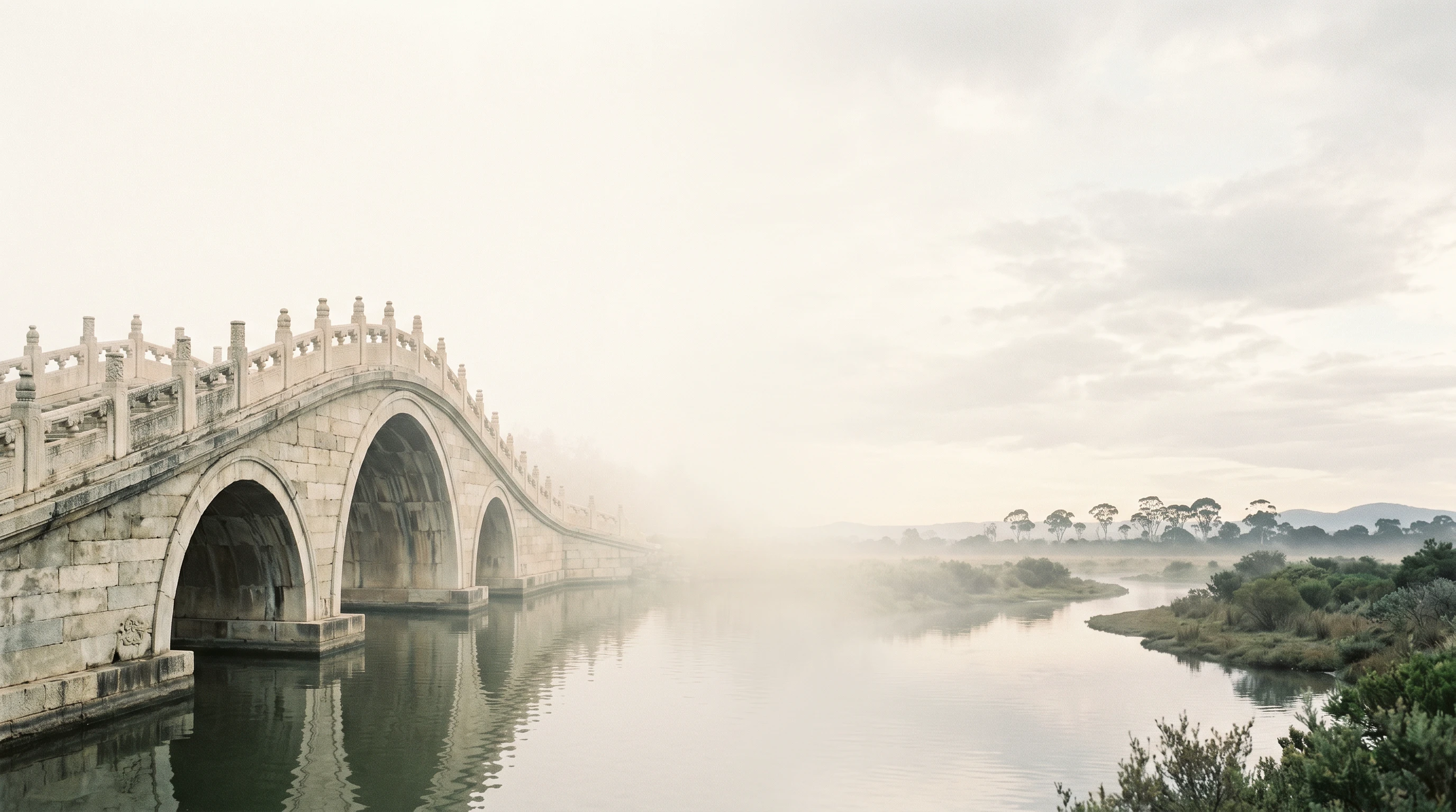 An ancient Chinese stone bridge dissolving into open Australian sky